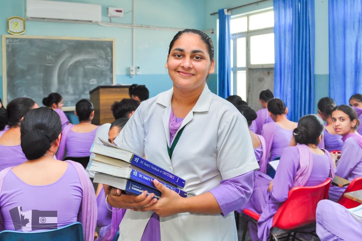 Navdeep Kaur in classroom with books - Punjab nursing college bursary program recipient