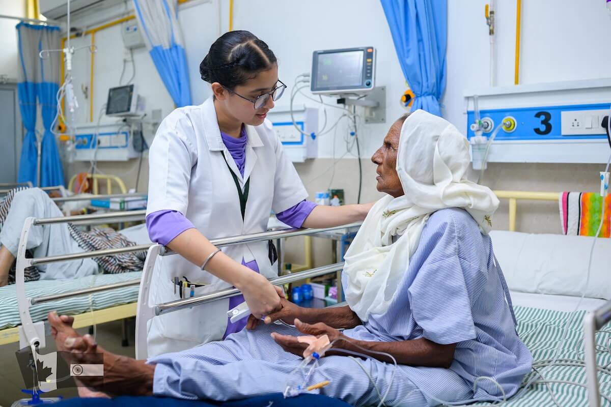 Nursing student caring for patient at Guru Nanak Mission Hospital in Dhahan Kaleran Punjab - a not-for-profit hospital