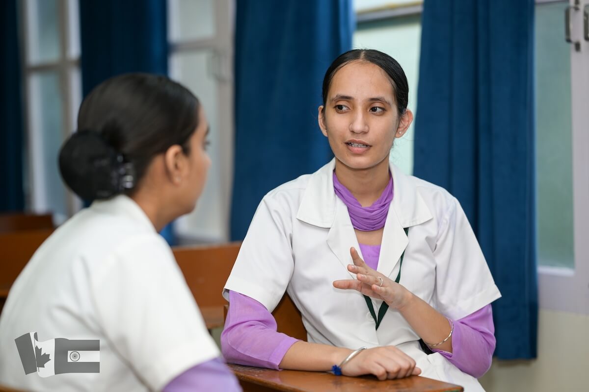 Bursary recipient at nursing college in Punjab - talking to classmate